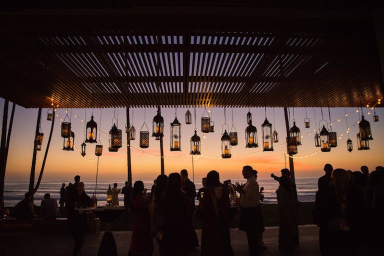 Beautiful California beach wedding with lanterns as decor | PartySlate