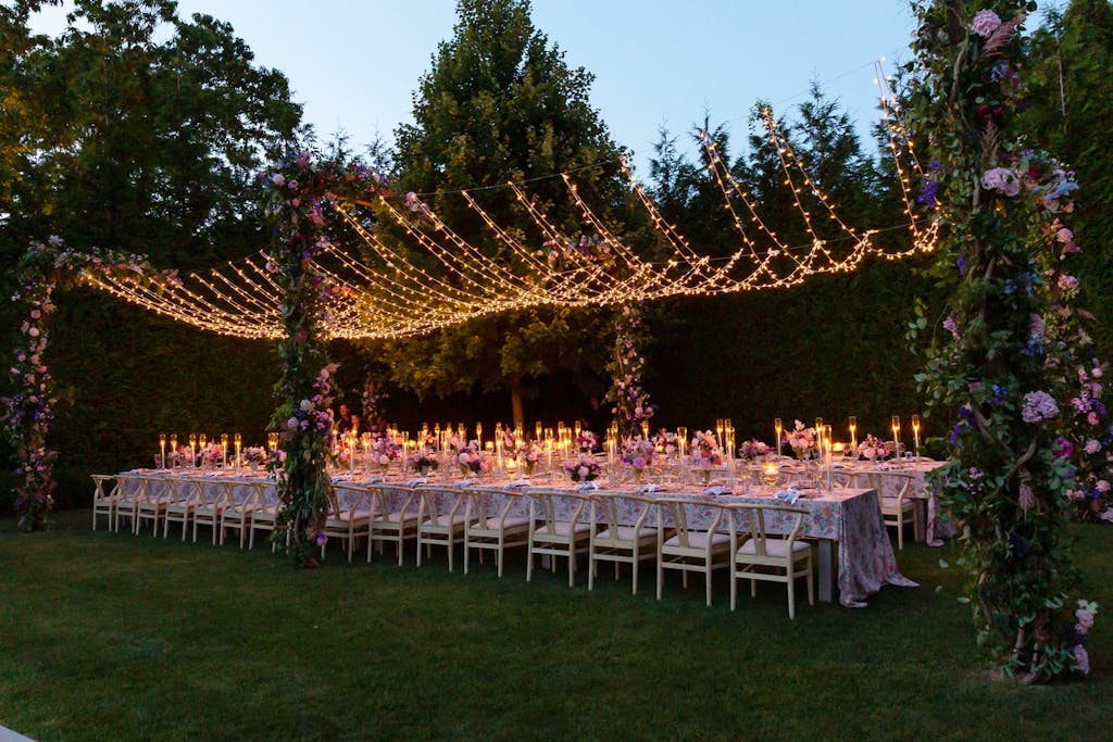 String Light Wedding Tent Structure With Floral Pillars | PartySlate