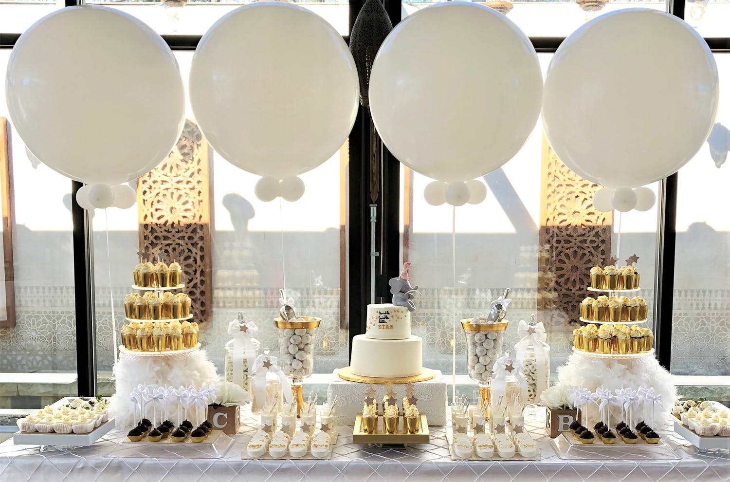 White and Gold Baby Shower Dessert Station with White Balloons | PartySlate