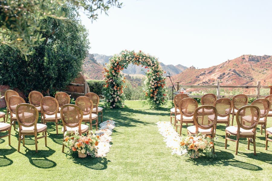 Mountain view micro wedding with a floral arch | PartySlate