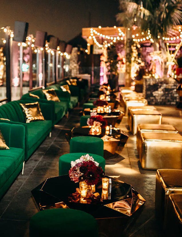Crazy Rich Asians premiere party with emerald green couches and gold décor