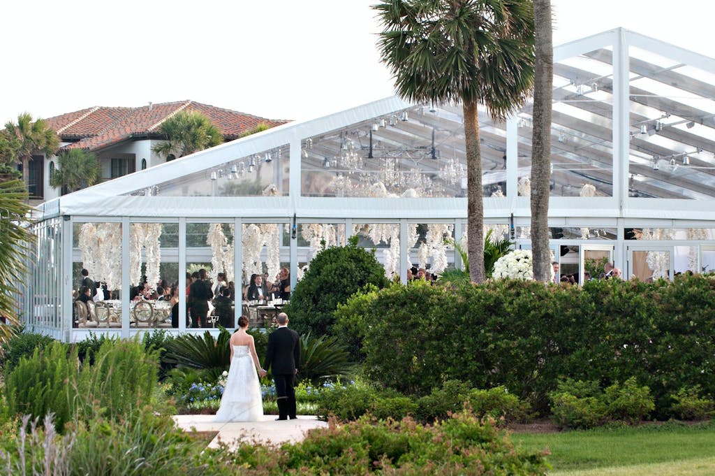 Clear Wedding Tent With White Flower Ceiling Installation | PartySlate