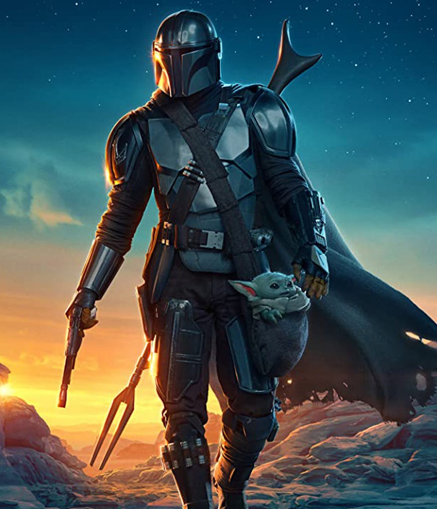 The Mandalorian from Star Wars walking through the desert in armour