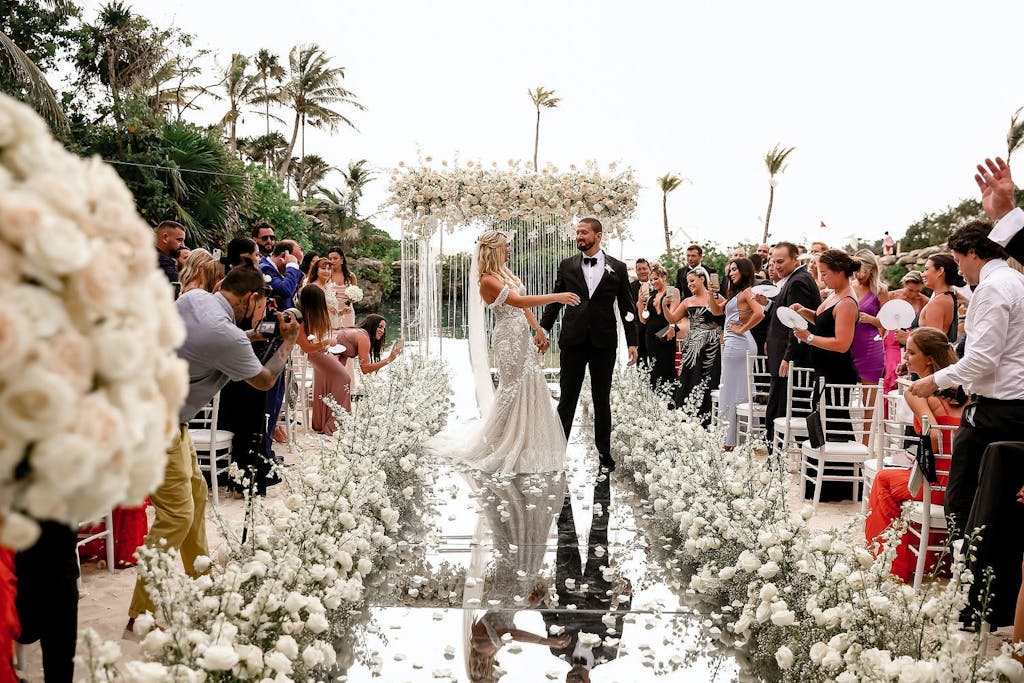 A bride and groom walking down he aisle.
