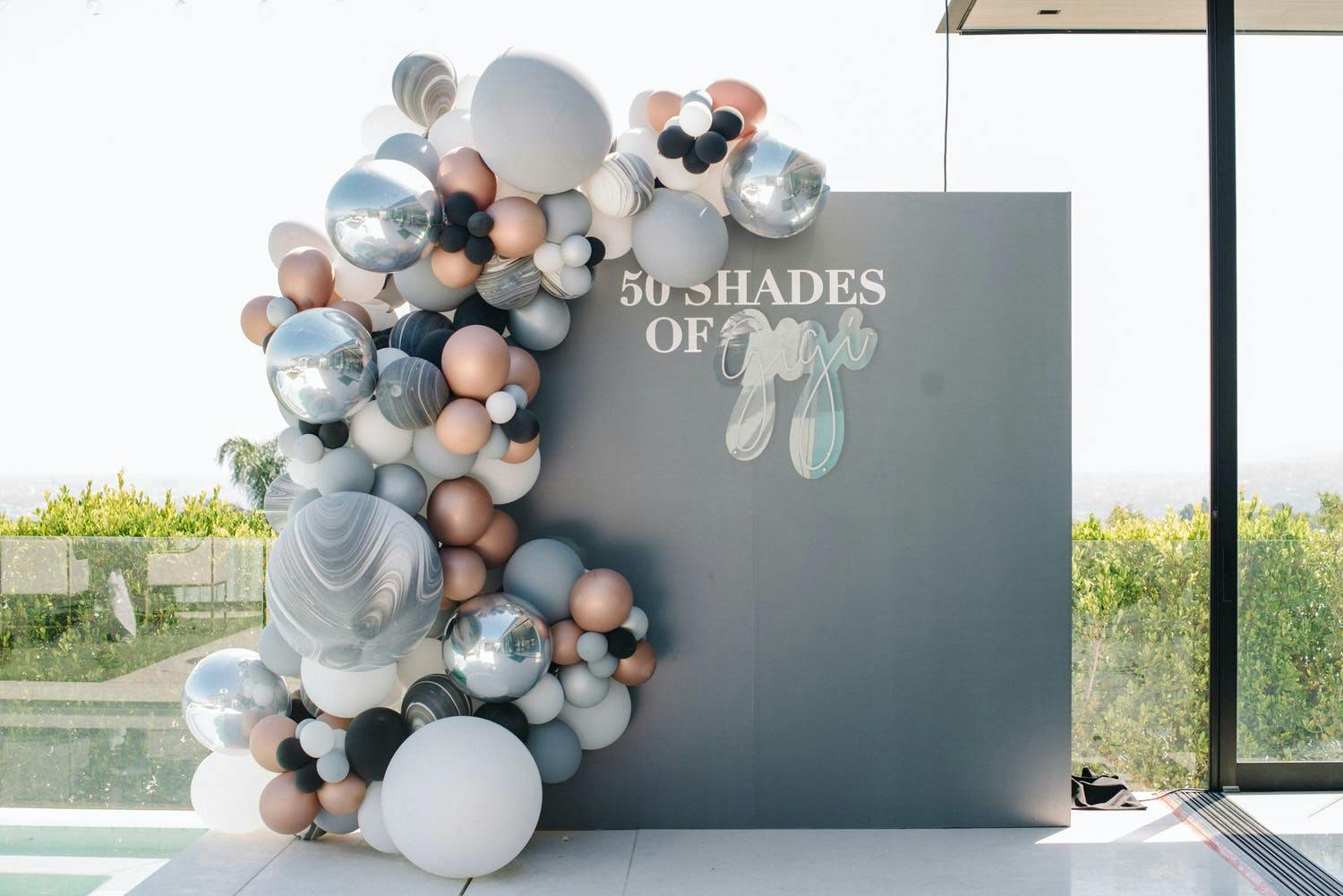 50 Shades of Gray-Themed Gray Birthday Backdrop With Metallic Balloon Installation | PartySlate
