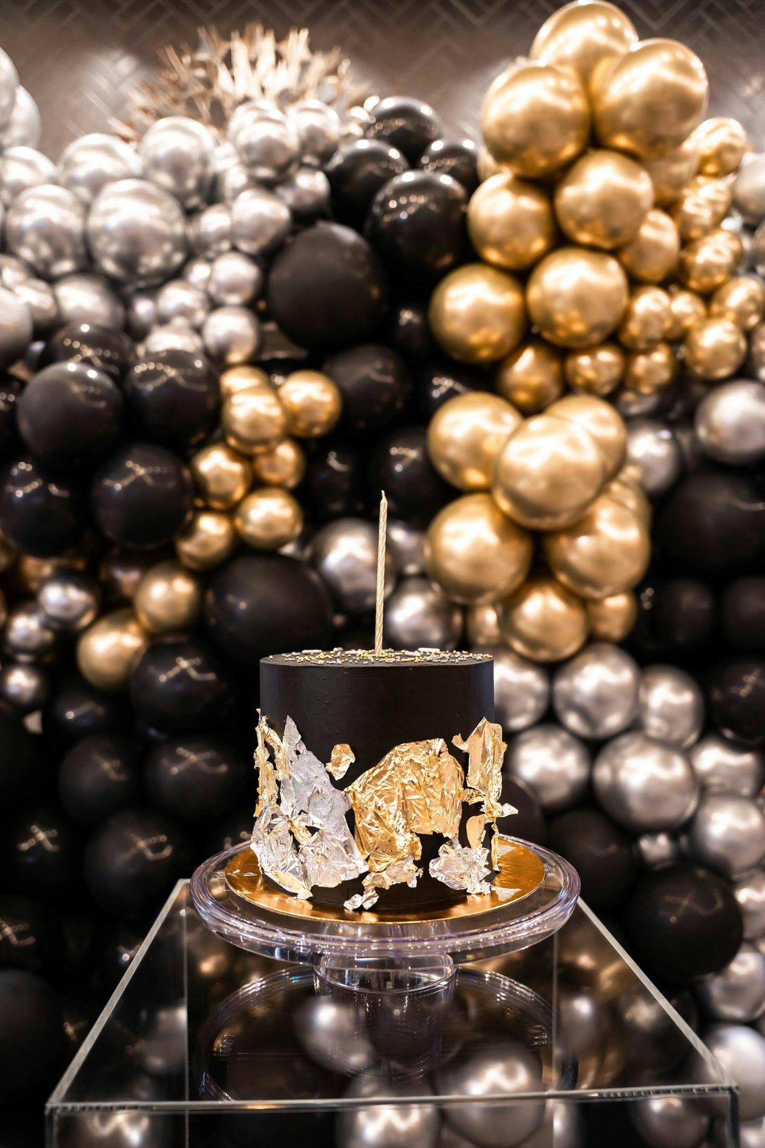 Black, Gold, And Silver Birthday Party With Giant Balloon Installation and Black Birthday Cake | PartySlate