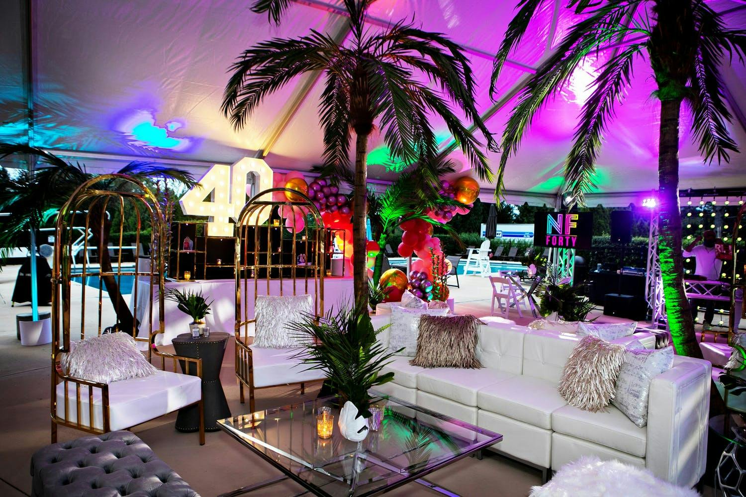 Chicago Tropical-Themed Birthday With Purple Uplighting and Palm Trees | PartySlate