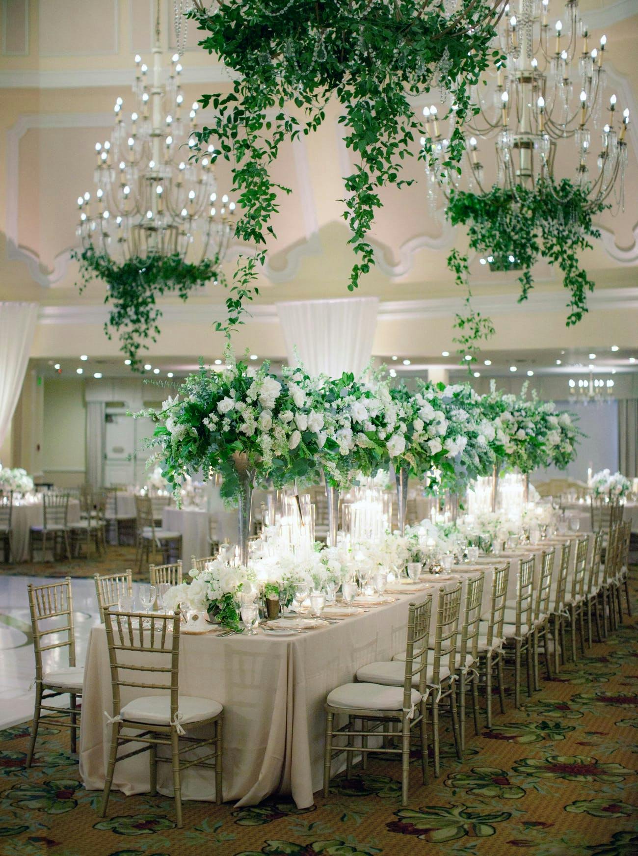 Enchanting indoor wedding with chandeliers and large florals | PartySlate