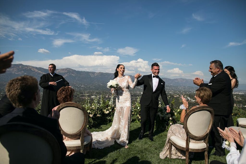 A bride and groom at their ceremony after saying "I-Do."