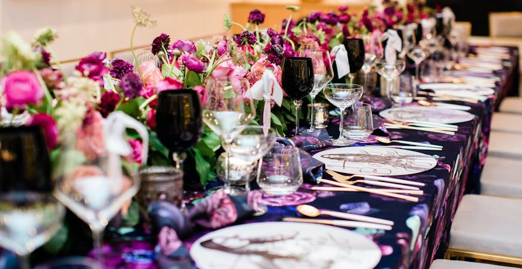 A purple tablescape with florals.
