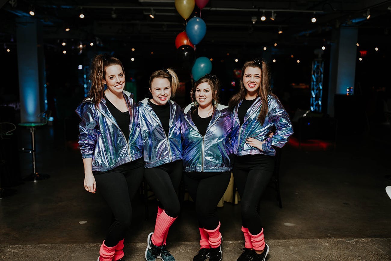 Four Friends Pose in 80s-Themed Attire | PartySlate