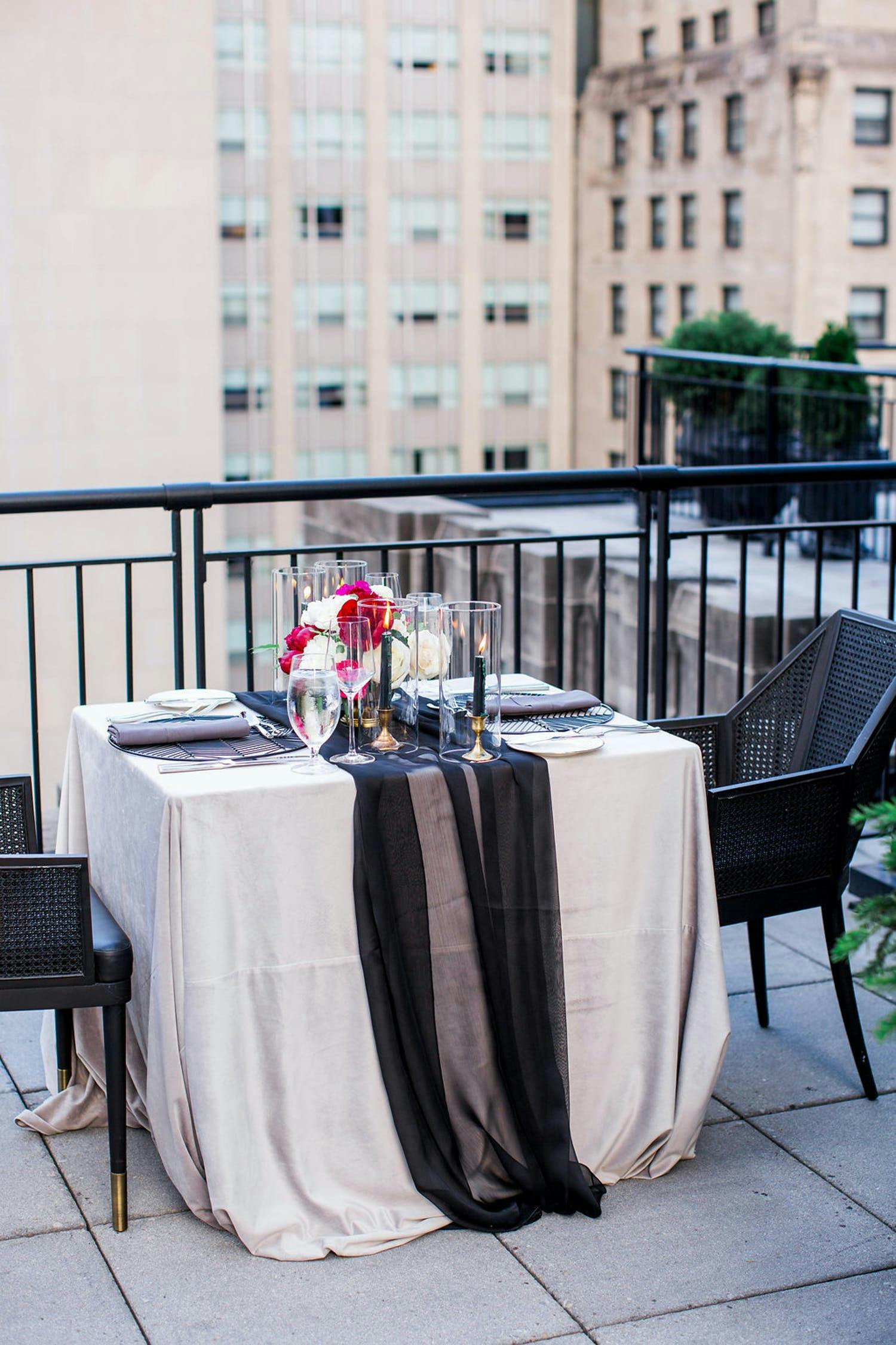 Intimate Rooftop Wedding Table at The Gwen With Black and White Linen and Pink Flowers | PartySlate