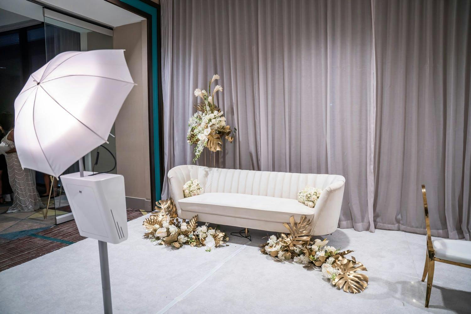 Minimalist Modern Wedding Décor Photo Op With White Sofa and Gold Florals | PartySlate