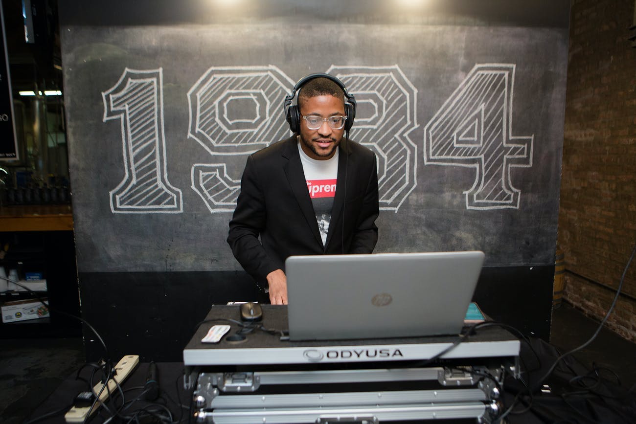 DJ Performs In Front of 1984 Chalk Signage | PartySlate