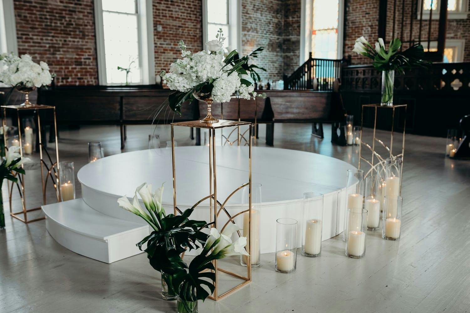 Modern Wedding Ceremony with Elevated Circular White Stand | PartySlate