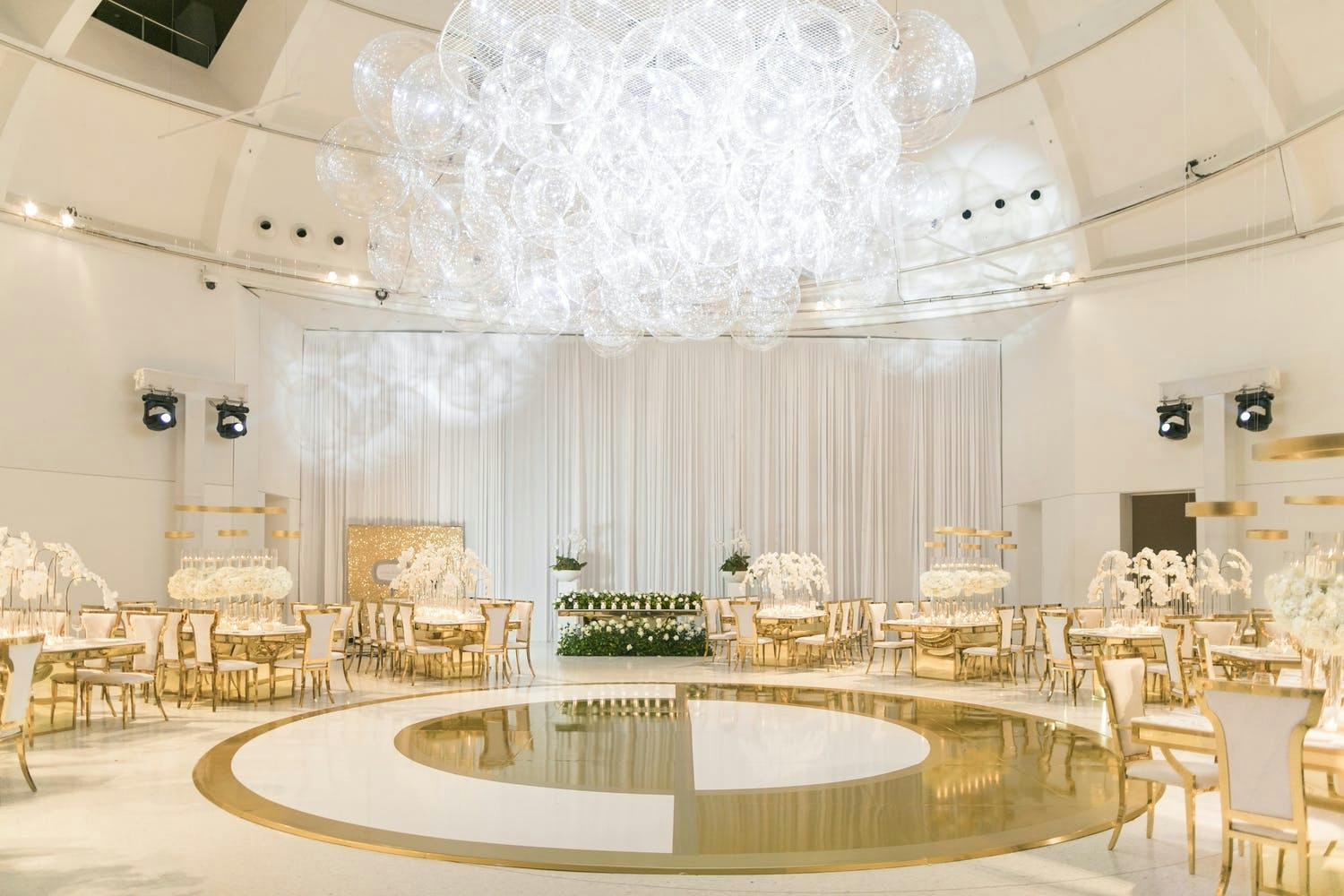 Wedding Ceremony With Yin and Yang-Inspired Gold and White Dance Floor and Lacey Bubble-Like Lighting installation | PartySlate