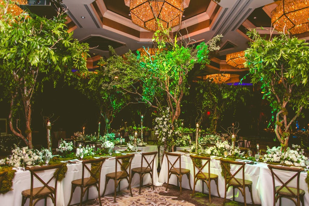 Indoor Enchanted Forest Wedding Theme With Towering Treetop Centerpieces and Amber Chandeliers | PartySlate