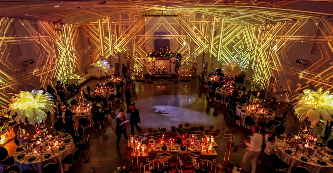 A Gatsby Party With Gold Art Deco Illuminating Against the Walls | PartySlate