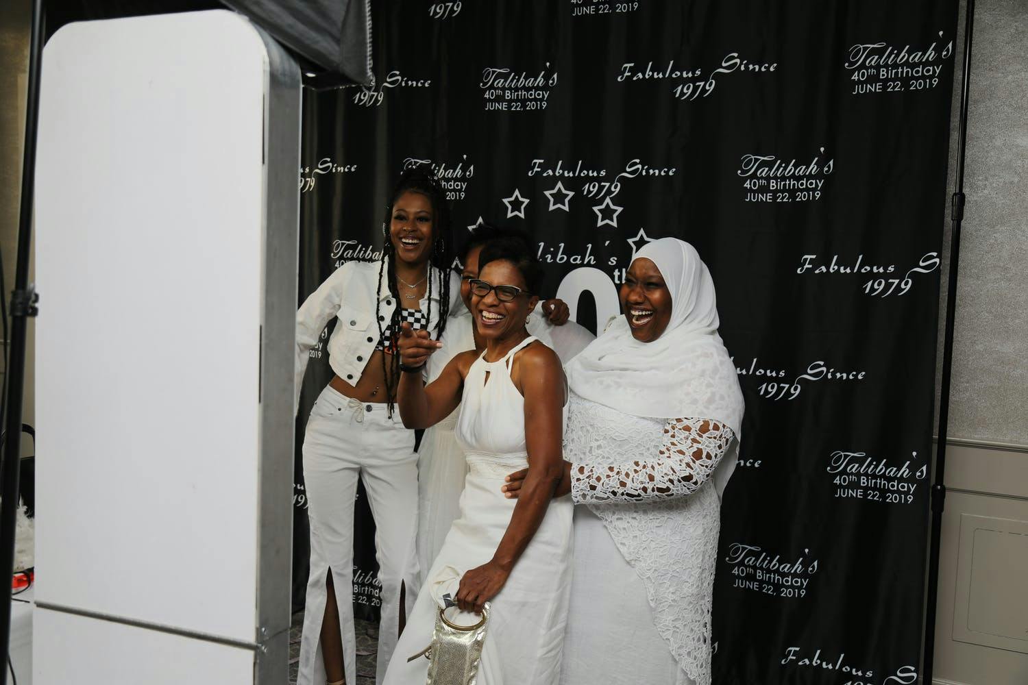 Guest, Dressed in White, Pose in Photo Booth at 40th-Birthday Party | PartySlate