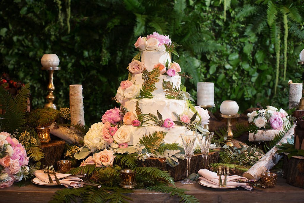 Enchanted Forest Theme Wedding Cake With Pink Roses and Ferns | PartySlate
