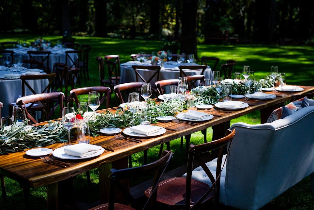 Outdoor Forest Wedding With Wooden Table and Garland Greenery Runner | PartySlate