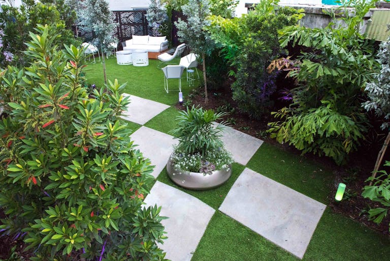 Outdoor event space in Miami with green turf and bushes | PartySlate