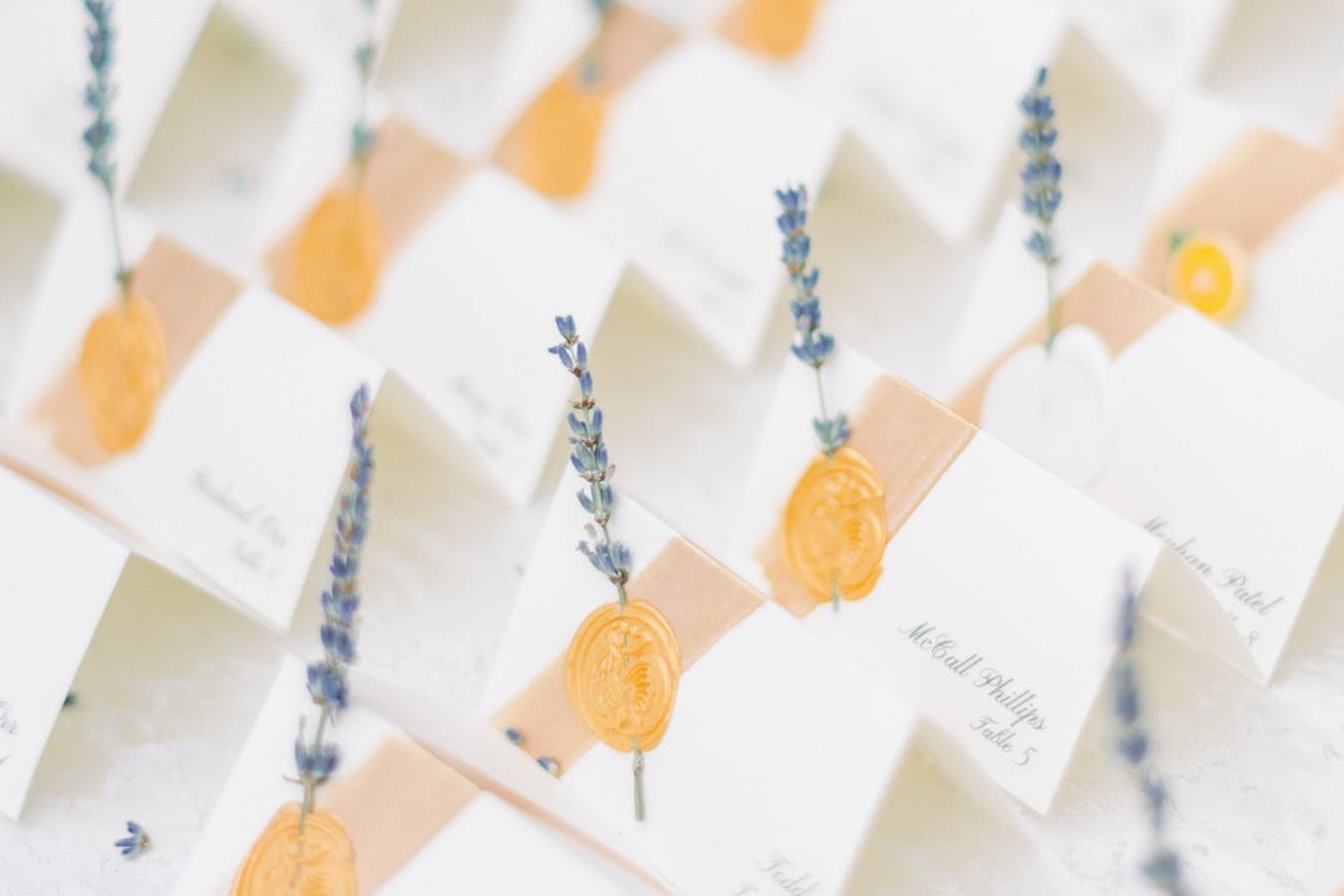 White Escort Cards With Gold Wax Seals and Sprigs of Lavender | PartySlate