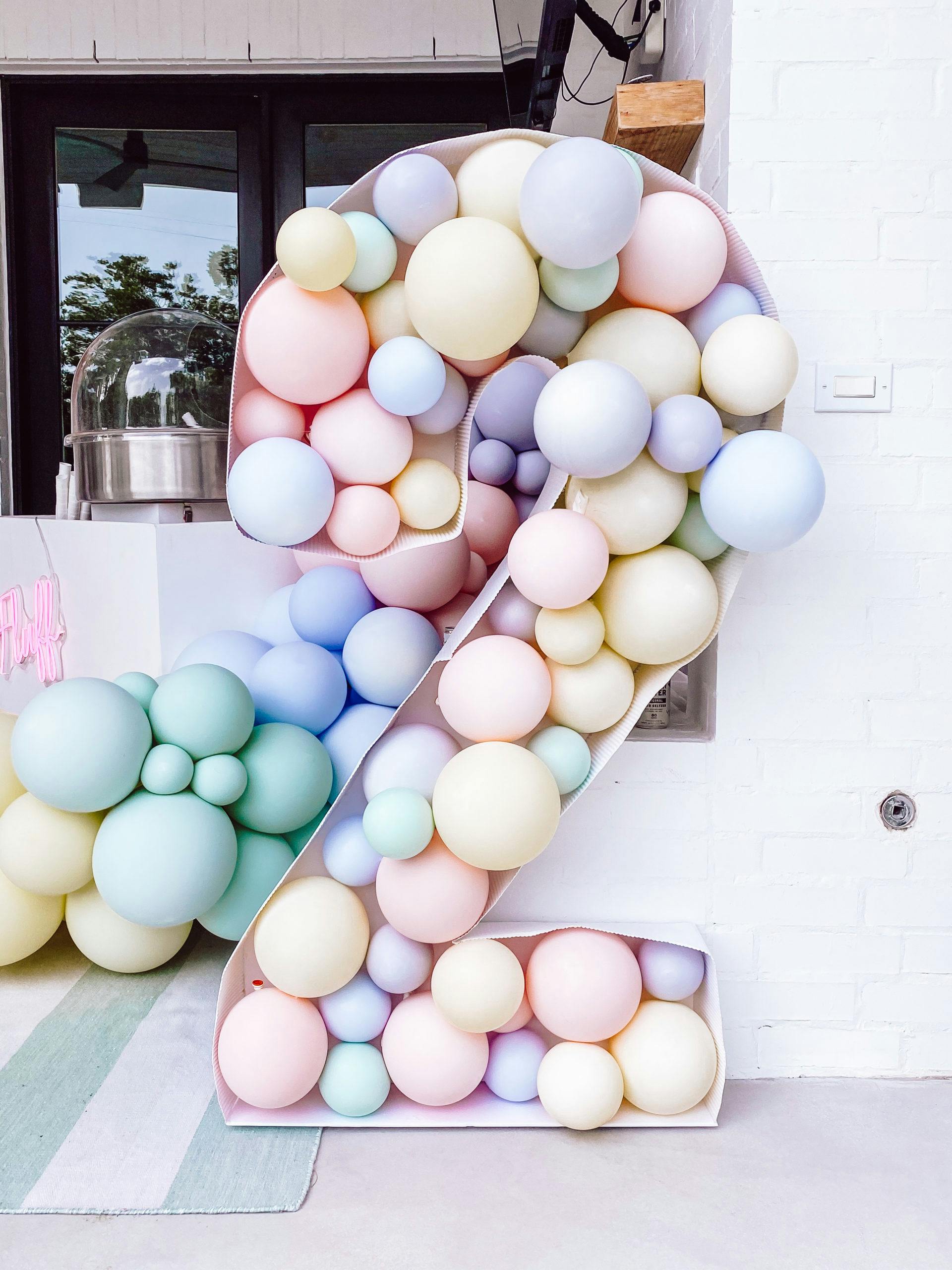 A Two Sweet Kids Birthday Party Celebration with Pastel Balloon Installation in the Shape of the Number Two | PartySlate