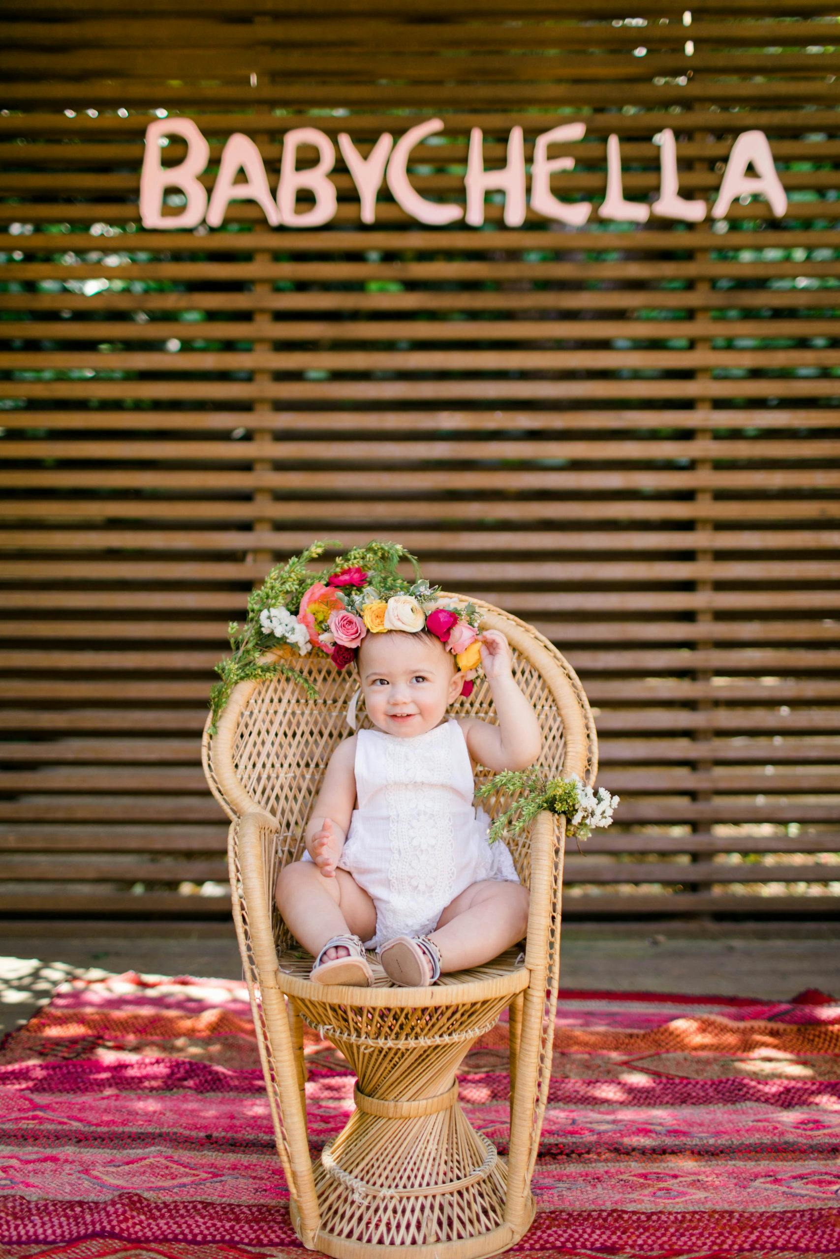 BabyChella Coachella Inspired Kids Birthday Party Idea with Baby Sitting in a Wicker Chair with a Flower Crown | PartySlate