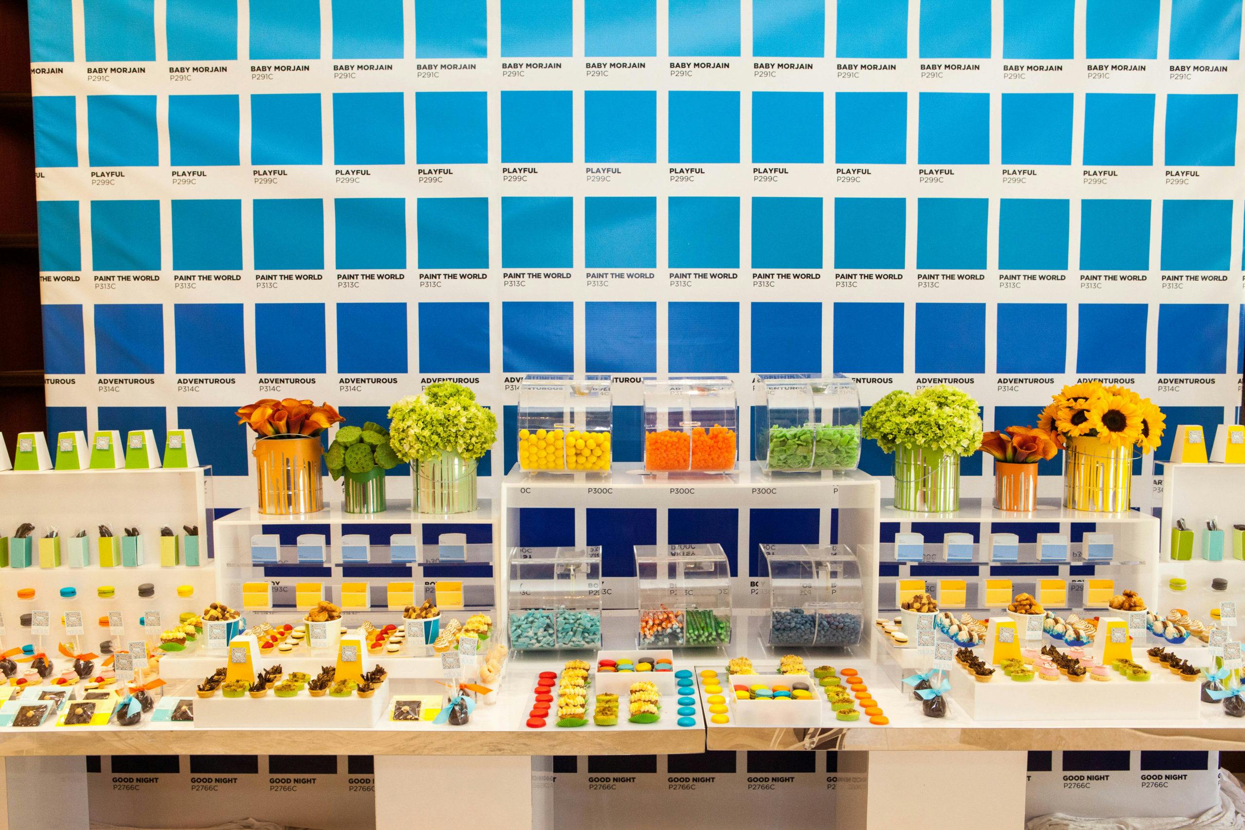 Colorful Creative Kids Birthday Party with Pantone Paint Swatches Filling the Walls Behind the Dessert Table | PartySlate