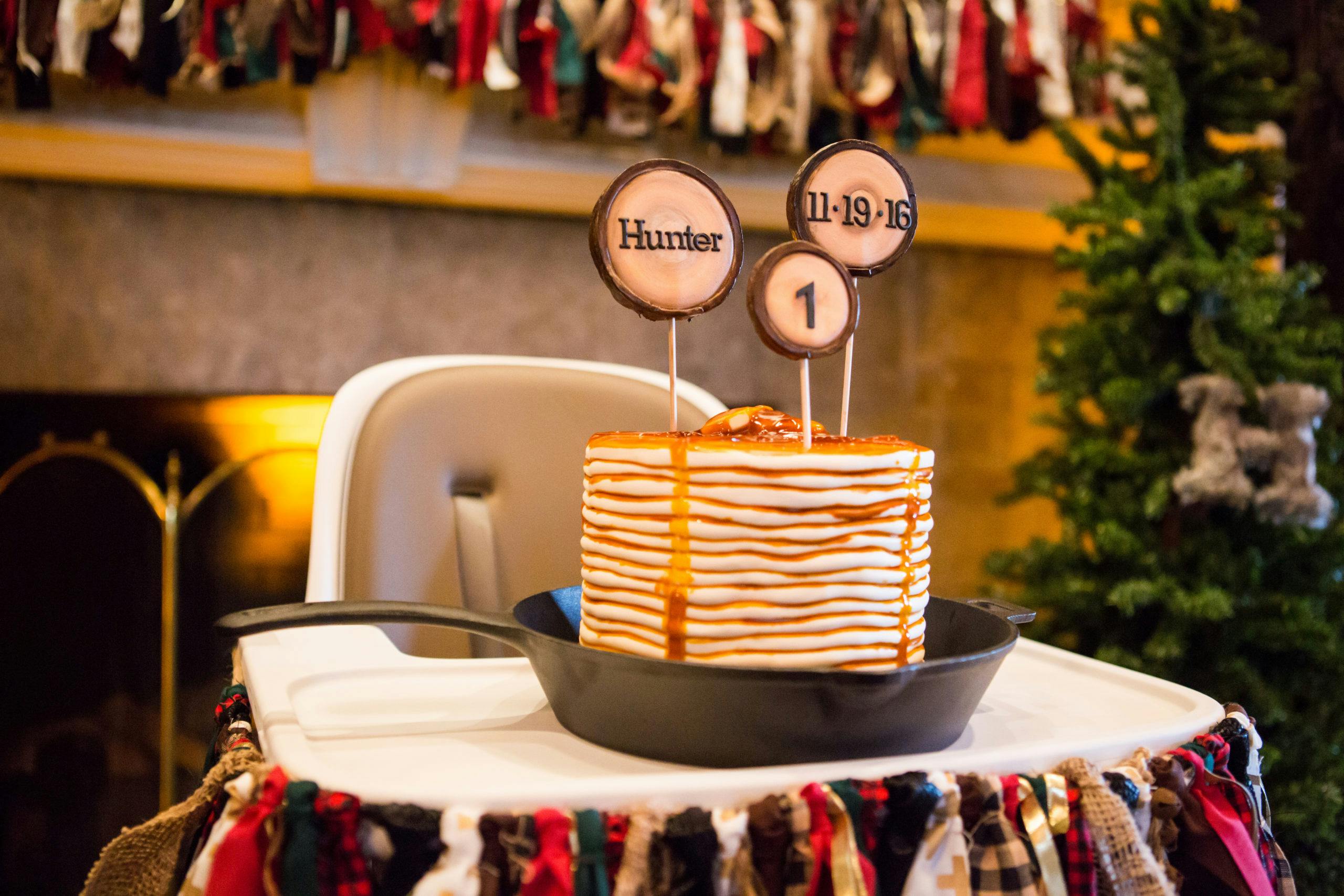 Kids Lumberjack Themed 1st Birthday Party with Flapjack Cake Sitting on a High Chair | PartySlate