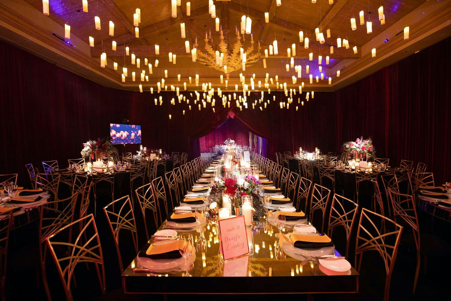 Glowing Candles are Suspended Over Mirrored Wedding Tablescape | PartySlate