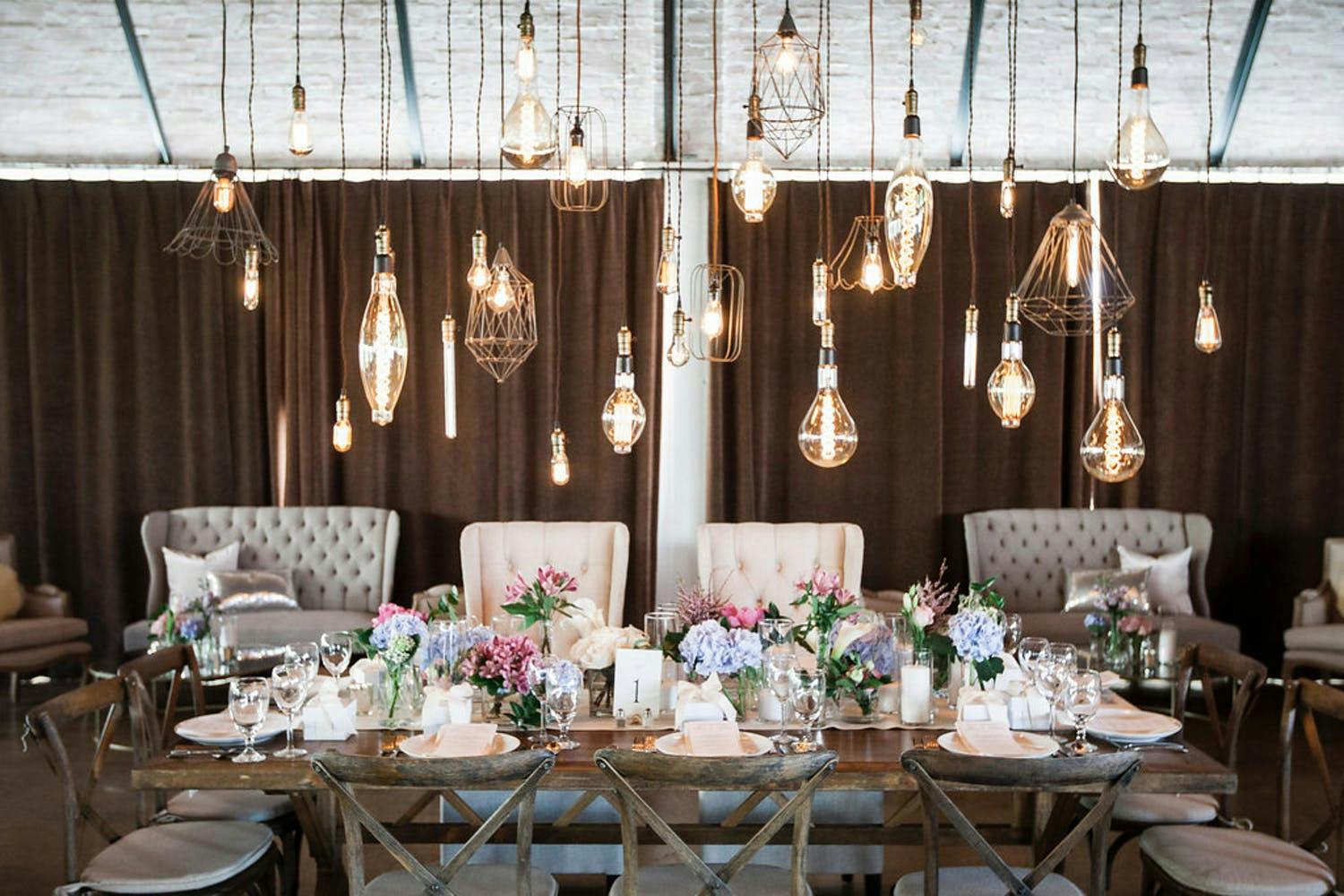 Wedding Party Table in Pastel Color Schemes With Geometric Lighting Installation | PartySlate