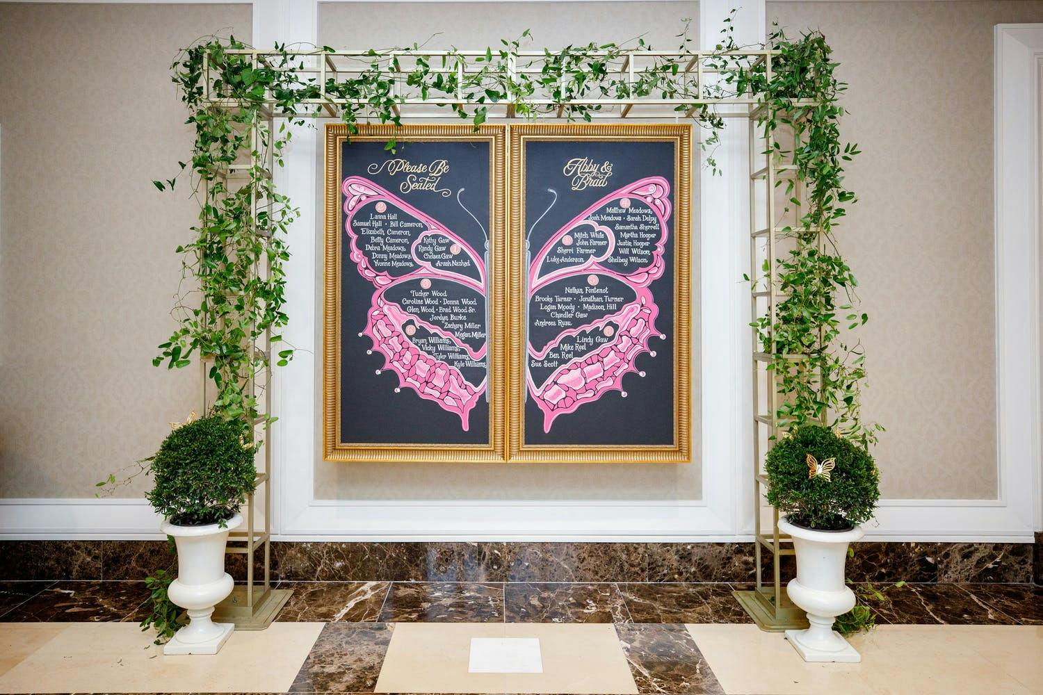 Chalk Signage With Butterfly Design and Wedding Seating Assignments | PartySlate