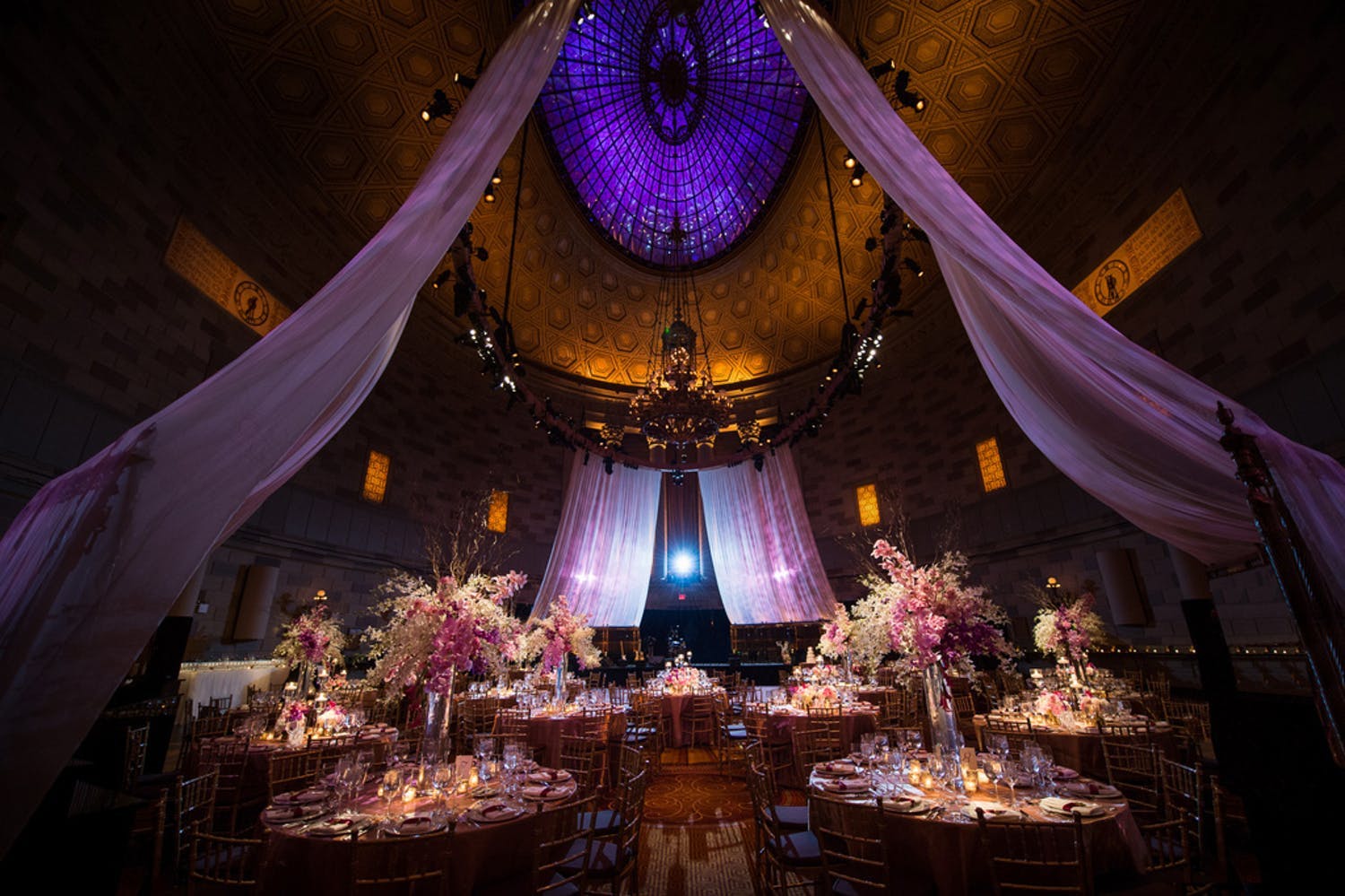 Dramatic Soaring Purple and Gold Ceiling With Ethereal Violet Wedding Drapery Suspended from Ceiling | PartySlate