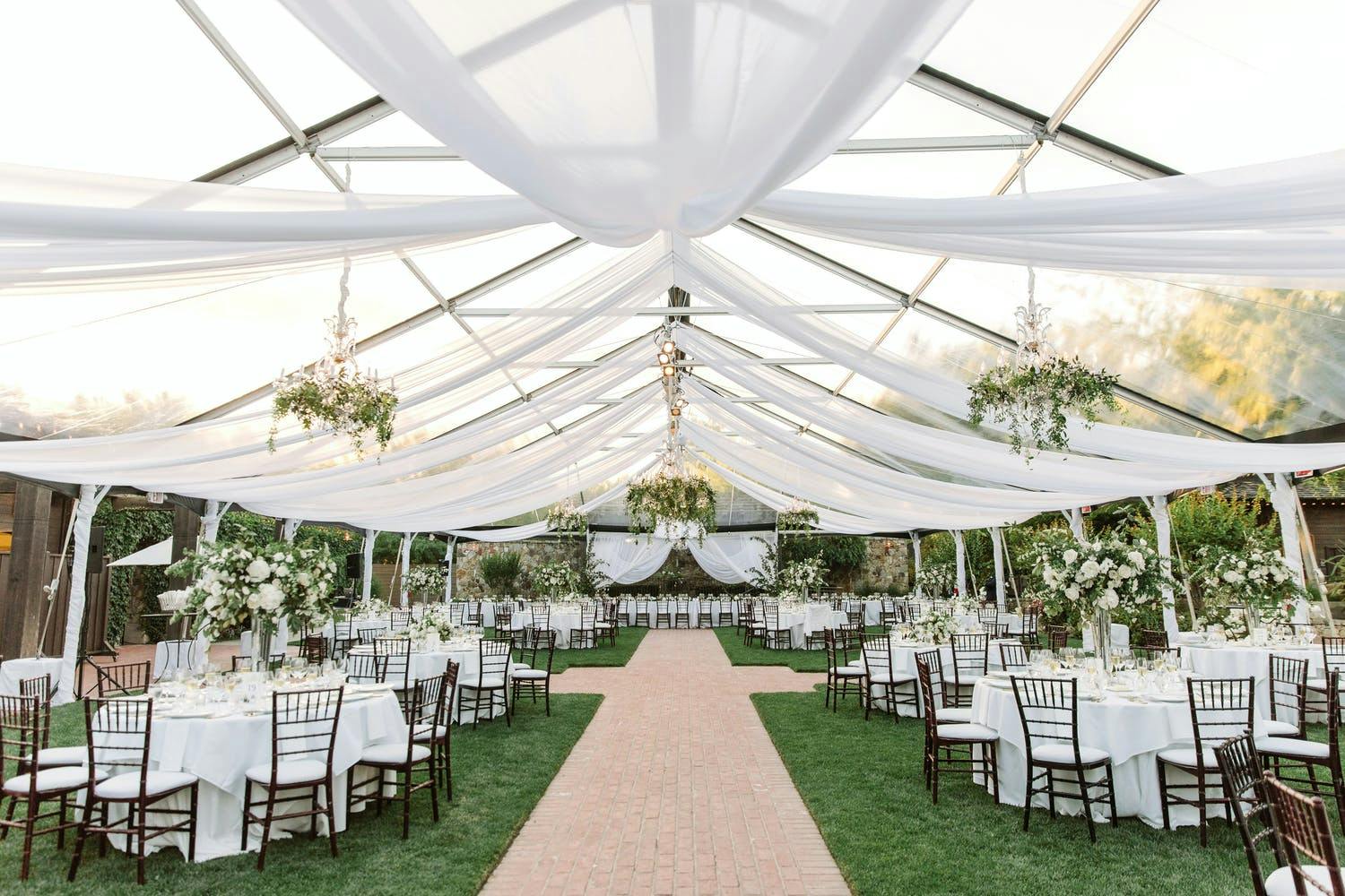Transparent Wedding Tent Reception Area with Sheer White Ceiling Drapery | PartySlate