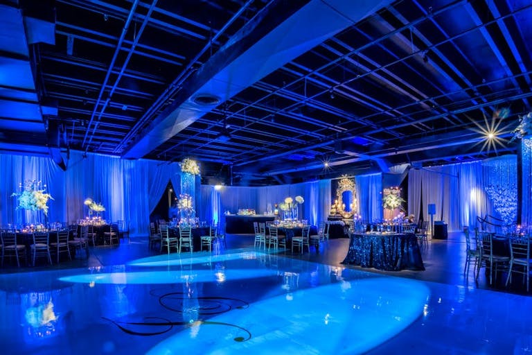 Blue Miami wedding venue space with LED light decor | PartySlate