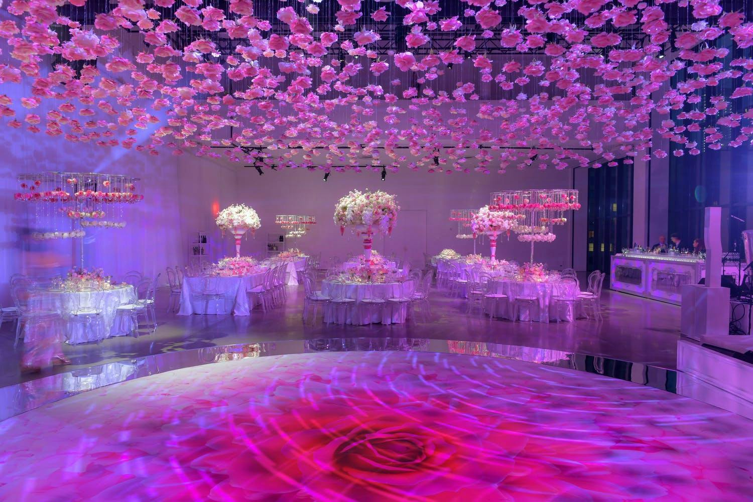 Pink-Toned Wedding With Bright Rose-Patterned Dance Floor and Suspended Pink Bloom Ceiling Installation | PartySlate