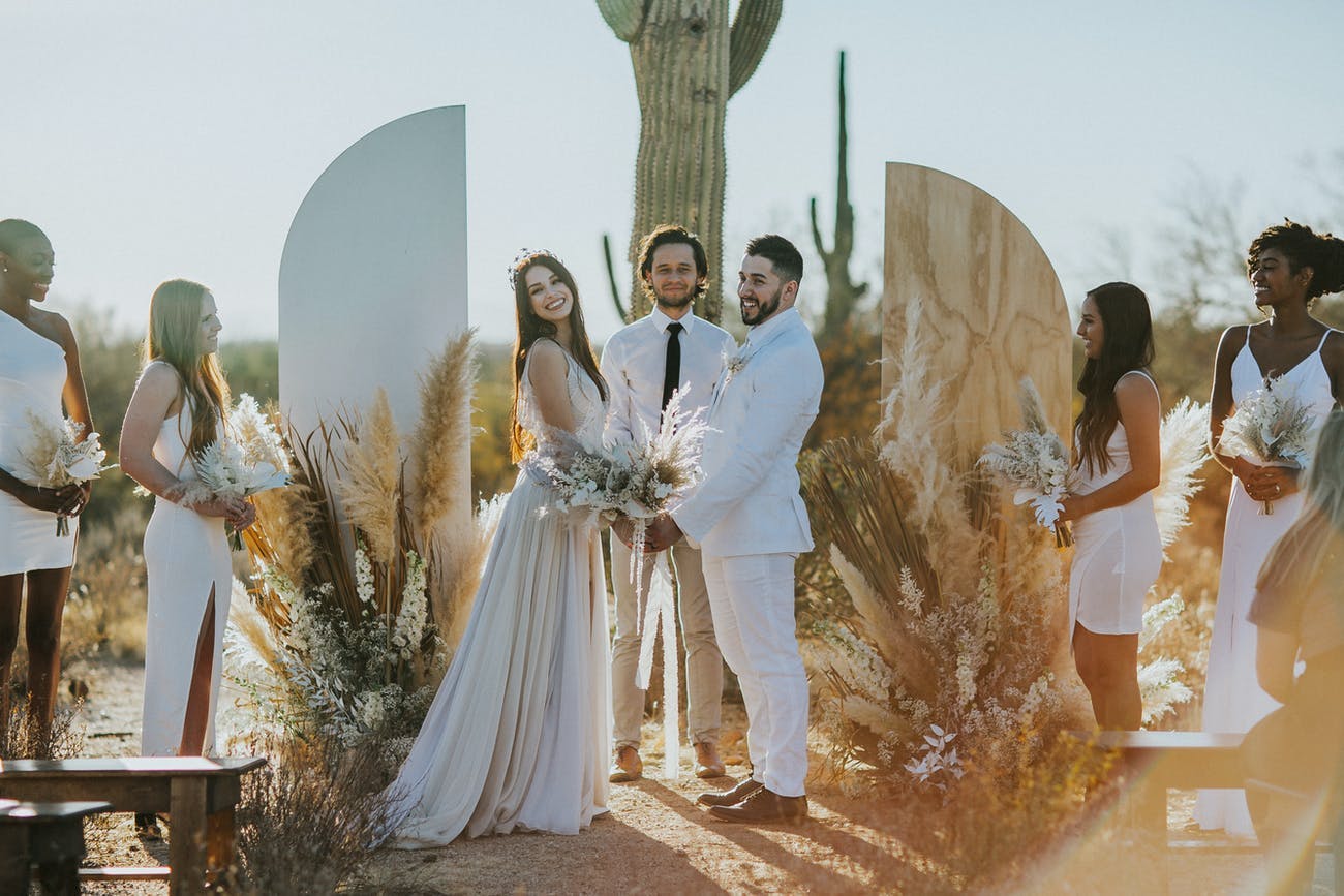 Boho Desert Wedding Ceremony With Wooden Arch and Florals | PartySlate
