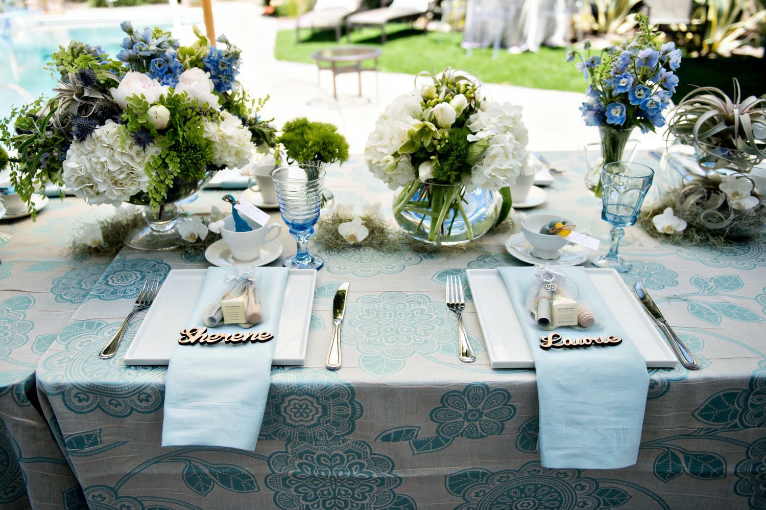 Rain-Themed Baby Shower Tablescape in Blue Color Palette With White Flowers and Greenery | PartySlate