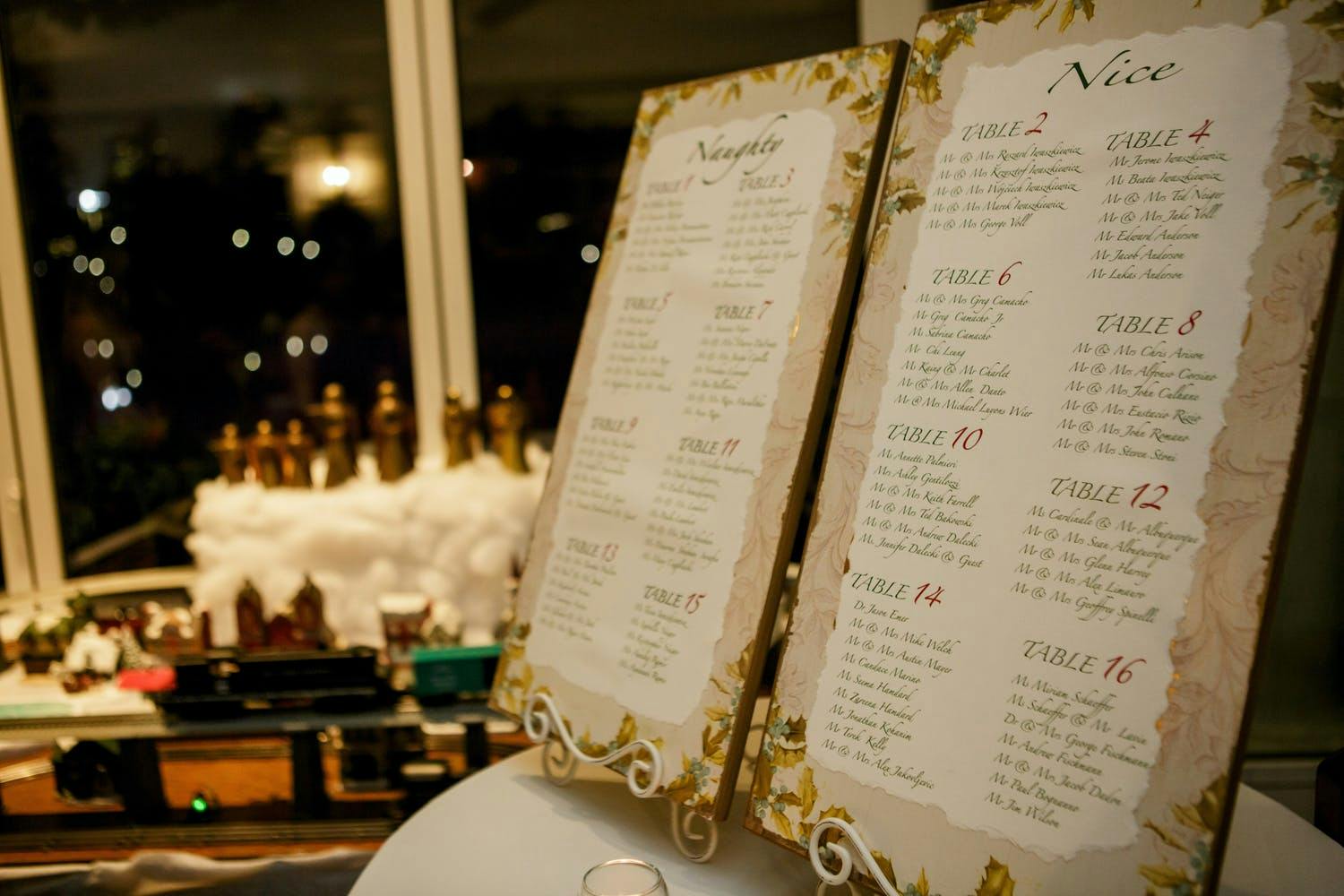 Gold-Edged Wedding Seating Chart With Poinsettia Designs for Christmas Wedding | PartySlate
