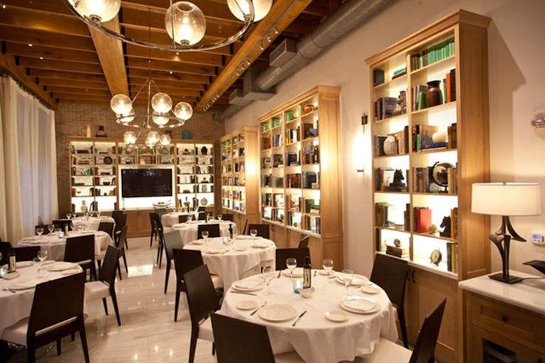 Estiatorio Milos Miami Private Dining With Cozy Light Color Palette and Book-Lined Shelving | PartySlate