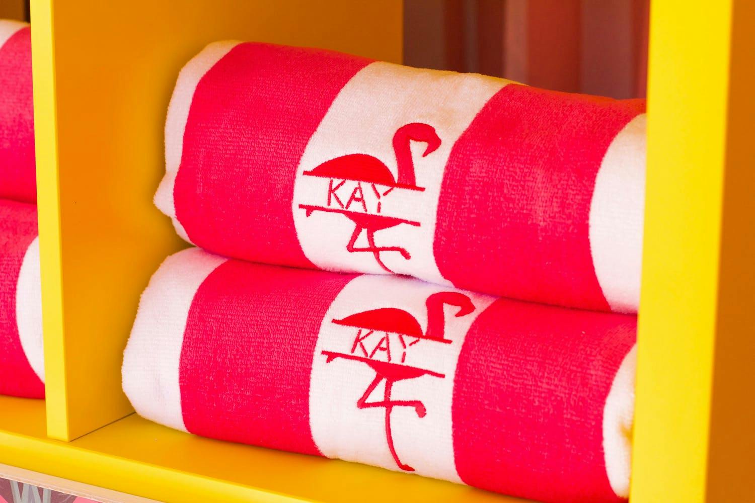 Pink and White Flamingo Towel Party Swag in Yellow Shelving | PartySlate