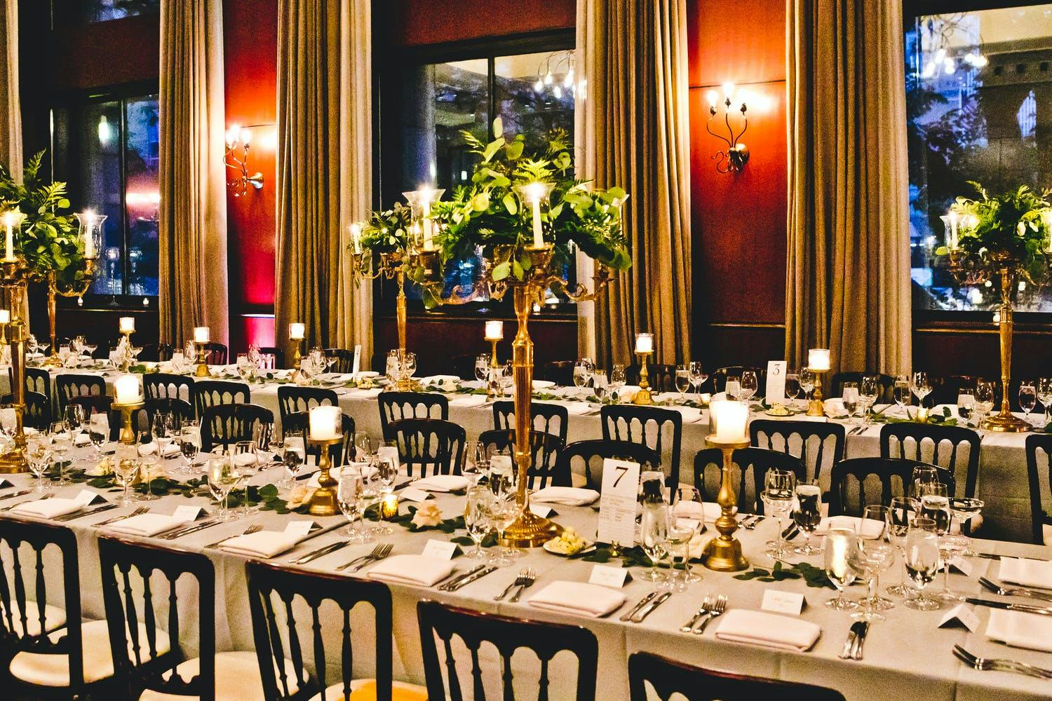 Wedding at The Newberry Library With Gold Candelabra Centerpieces Wrapped in Greenery | PartySlate