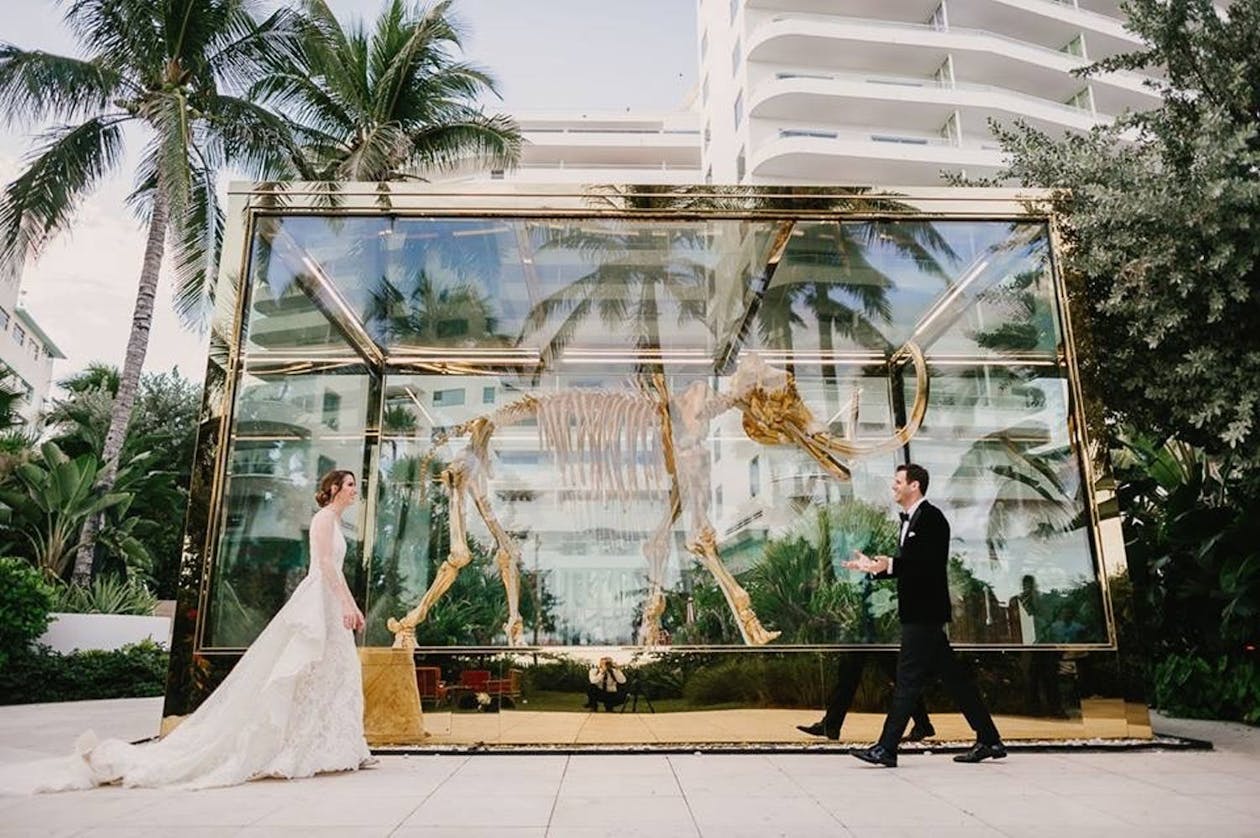Bride and Groom Have First Look at Faena Hotel in Front of Damien Hirt’s Mammoth Sculpture in Miami Beach, FL | PartySlate