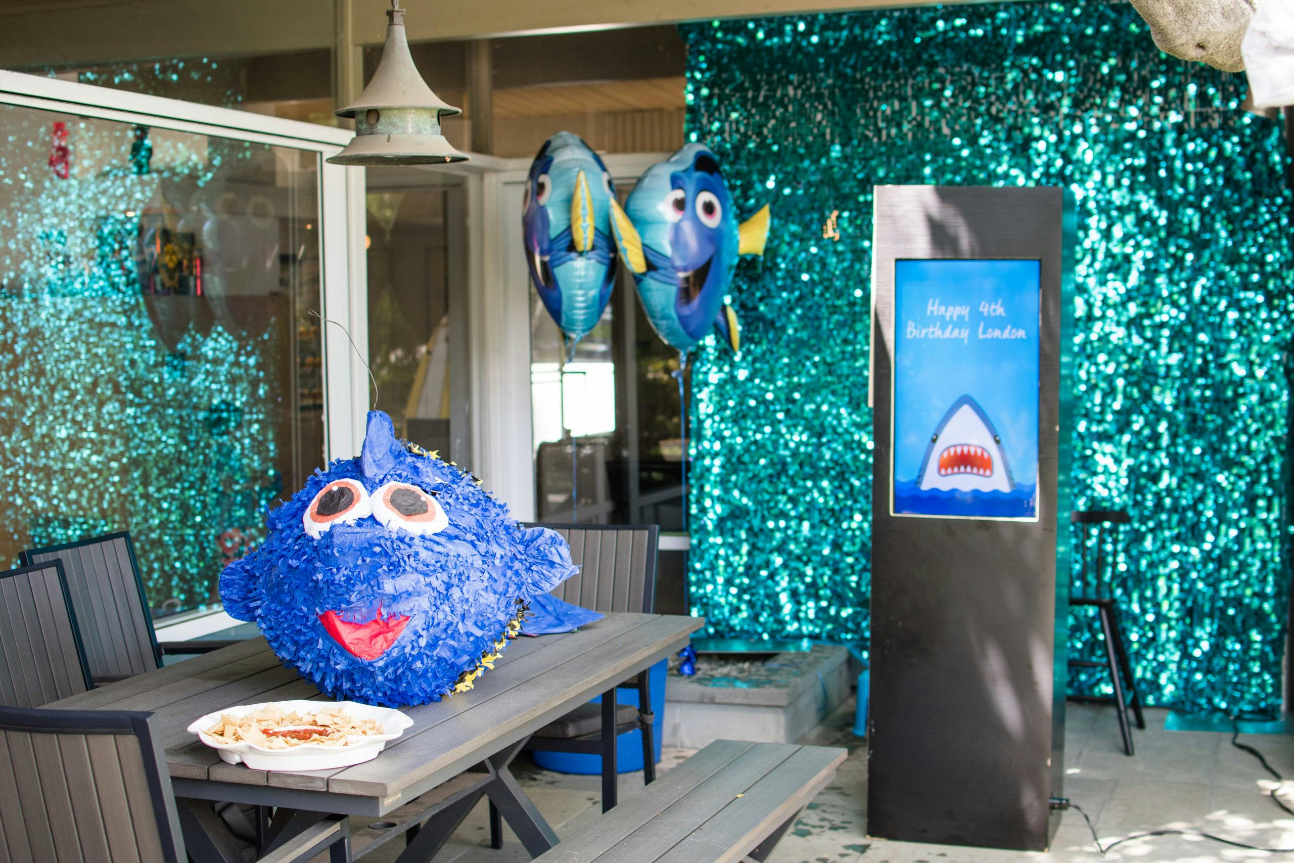 Shark Attack Themed Kids 4th Birthday Party with Shark Photo Booth Props and Blue Streamers | PartySlate