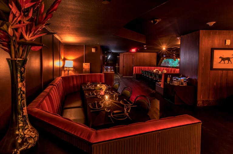 Dining Room at El Tucán With Red Booth and Moody Lighting in Miami, Brickell Neighborhood | PartySlate