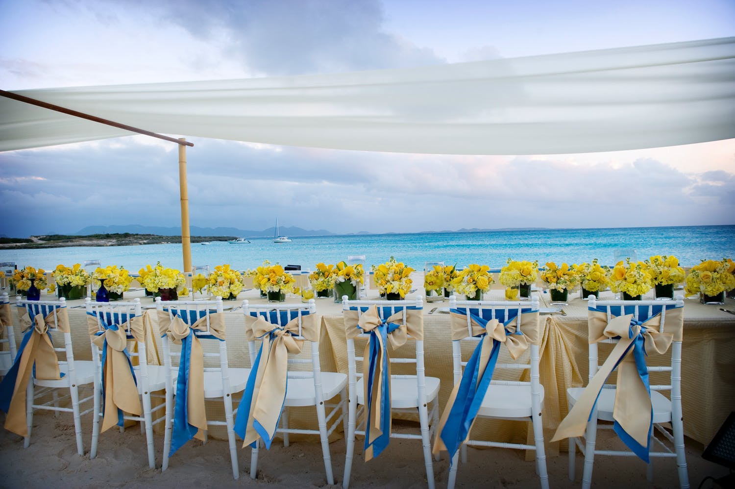 Seaside Wedding Tablescape With Bright and Cheerful Yellow Blooms | PartySlate