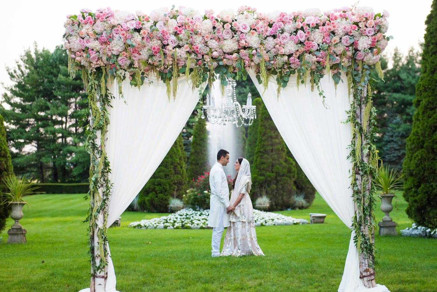 Mandap With Sparkling Chandelier and Crown of Pink Roses | PartySlate