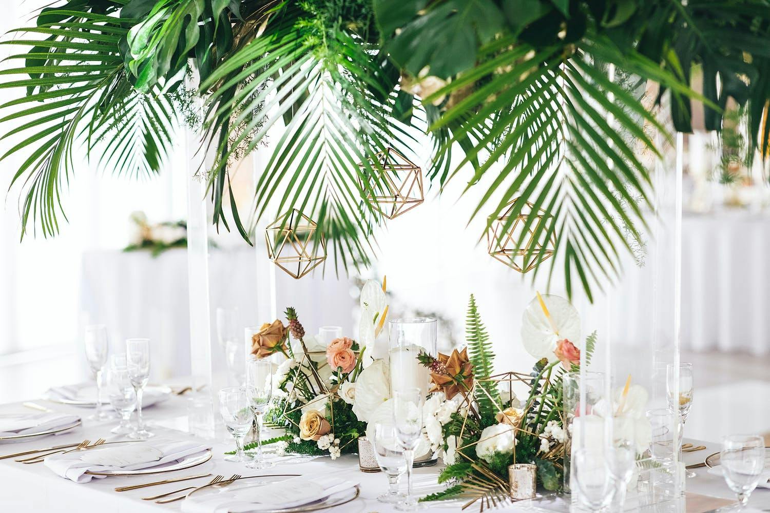 Wedding Centerpiece With Gold Geometric Terrariums (and Vibrant Tropical Foliage) | PartySlate